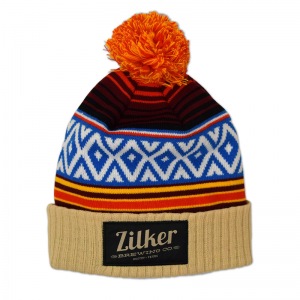 Zilker knit pom beanie with woven label patch.