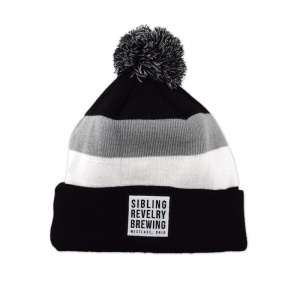 Sibling Revelry knit pom beanies with woven patch.